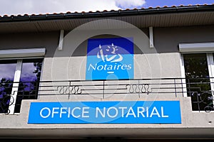 Notaire office notarial label french text sign and brand logo front of wall notary photo