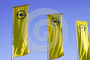 opel logo brand car sign text in three yellow flag in blue sky