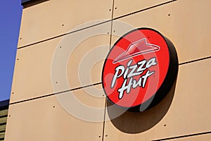 Pizza Hut text sign and brand logo front wall of Fast food Casual Restaurant