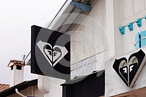 Roxy shop brand logo and text sign on wall building facade fashion surf store