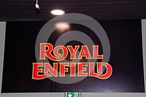 Royal Enfield motorcycle logo brand and text sign of indian motorcycle dealership wall