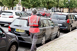 Traffic warden civil enforcement officer issuing parking ticket fine in bordeaux