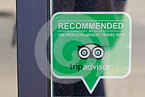 Tripadvisor recommended logo brand and sign text on shop windows store front of