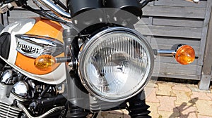 Triumph bonneville headlight motorcycle and detail sign text and logo on orange white