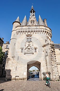 Bordeaux city, Porte Cailhau and woman on bike in France, Nouvelle aquitaine