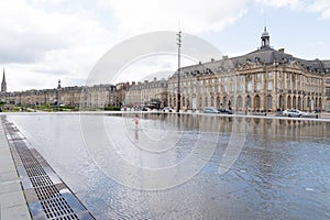 Bordeaux, Gironde / France - 05 26 2019 : Place de la Bourse with in front the mirror fountain Mirroir d`eau