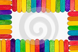 Border of colored lollipop sticks with blank white interior