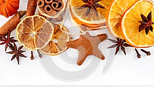 Border of dried oranges, lemons, mandarins, star anise, cinnamon sticks and gingerbread, isolated on white