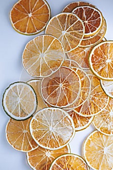 Border of Dried slices of various citrus fruits on white background