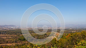 The border fence running through the Korean DMZ from South Korea photo