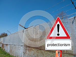 Border fence with warning sign protectionism