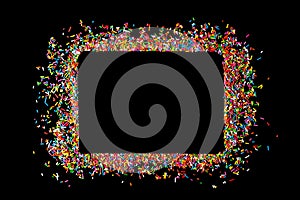 Border frame of colorful sprinkles on a black background with co