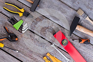 Border frame of construction tools on rustic background.