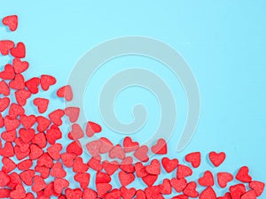 Border frame of red hearth-shape sprinkle on blue background