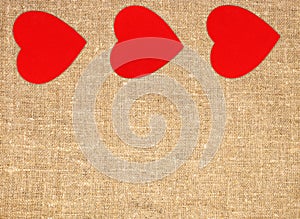 Border frame of red hearts on sack canvas burlap background