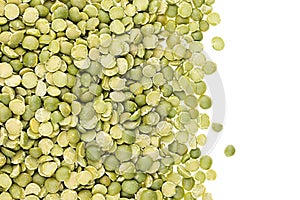 Border of green dry purified peas closeup with copy space on white background.