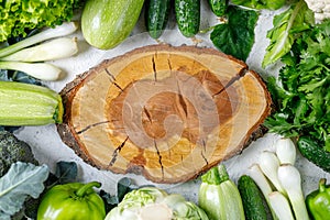 Border of green raw vegetables around empty cutting board. Place for your product or text.