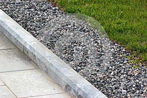 Border kerb between lawn and sidewalk in a park photo