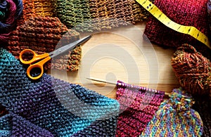 Border of knitting, wool, craft scissors and tape measure