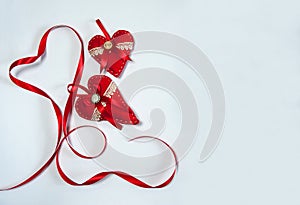 The border is made of hand-sewn decorative red hearts with ribbons and lace on a white background.