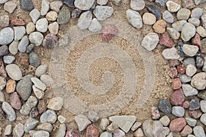 Border made of pebble stones on sand