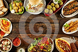 Border of Mediterranean dishes and bread on table photo