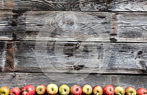 Border of organic apples on old genuine wood, flat lay