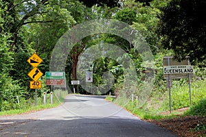 Border of Queensland and signage to the Natural Bridge and Nerang, Australia