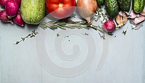 Border with radish courgette tomato cucumber onion herbs, concept autumn vegetables photo