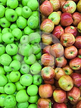 Border of red and green apples lying in a tray