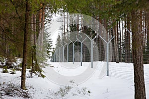 The border of the reserve in a dense winter snowy forest.