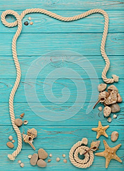 Border with rope, stones, sea shells and starfish on a turquoise