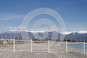 The border of Russia and Abkhazia, a fence and mountains.