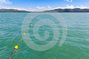 Border of safety area marked with line of yellow plastic buoys