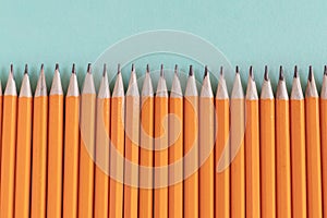 Border of sharpened orange pencils, with copy space.