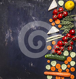 Border Vegetarian food concept tomatoes on a branch carrot cucumber lemon herbs. on wooden rustic background top view place for te