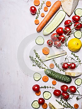 Border Vegetarian food tomatoes on a branch carrot cucumber lemon herbs place for text on wooden rustic background top view