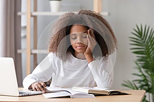 Bored african american teen student tired of learning doing homework