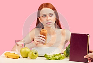 Bored apathetic woman eats croissant staring off into space ignoring raw fruits