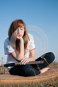 Bored Beautiful girl with computer