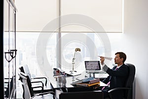 Bored Business Man Throwing Paper Airplane In Office