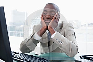 Bored businessman looking at his computer