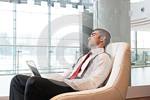 Bored businessman stares out window