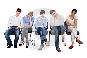 Bored businesspeople sitting on chairs