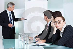 Bored businesswoman sleeping in a meeting photo
