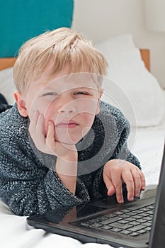 Bored child in his bedroom going online