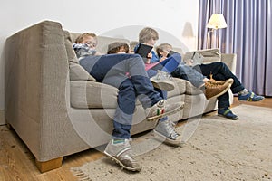 Bored children gaming on a couch