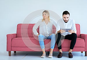 Bored and disregard couple lover sitting on couch at home together,Family issues photo