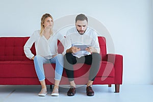 Bored and disregard couple lover sitting on couch in living room together,Family issues