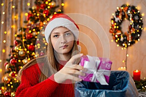 Bored dissatisfied girl disappointed with Christmas present